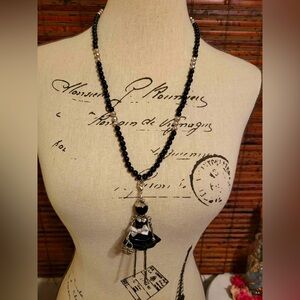 Elegant Black Beaded Necklace with Doll Pendant